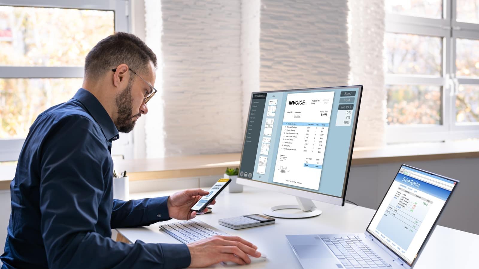 A young man reviewing an invoice while banking online